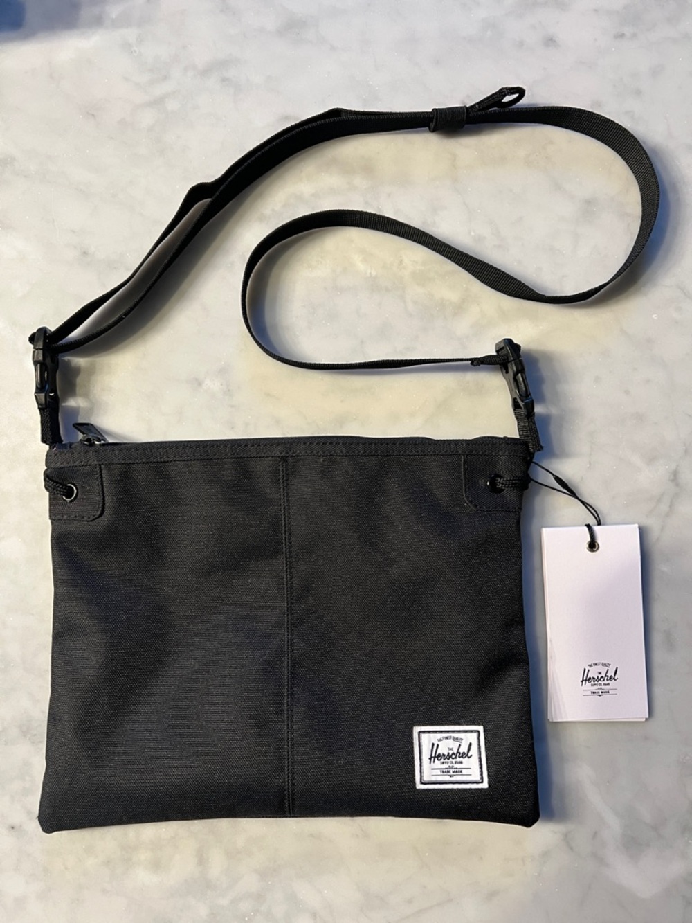 Herschel Black Crossbody Bag. Red lining. Zip top. NWT
